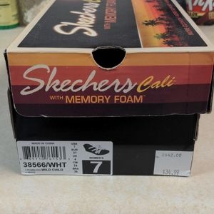 White Sketchers sandals